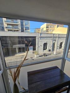a window with a table and a view of a building at Departamento Caseros Centro in Salta +63 photos