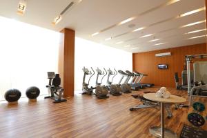 a gym with a row of treadmills and machines at Courtyard by Marriott Kochi Airport in Nedumbassery