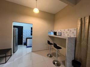 a living room with a counter and stools at Simply Suite Homestay in Parit Raja