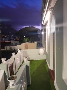 a balcony of a building with a green lawn at BKaap1 Queens and Kings Guest House in Cape Town