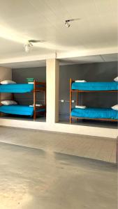 a room with blue bunk beds on the wall at La Fabrica in Yacanto +18 photos