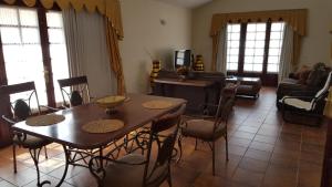 a living room with a wooden table and chairs at Exclusively located Golf Villa with heated pool in San Miguel de Abona