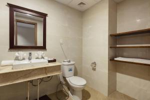 a bathroom with a toilet and a sink and a mirror at Maro Hotel & Apartment in Nha Trang +85 photos