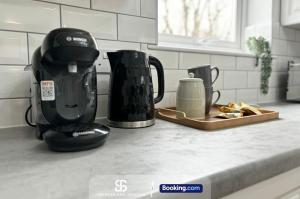 a kitchen counter with two appliances on a counter top at 2 Bedroom Spacious Duplex with Free Parking Near The University - By Spencer & Jackson Short Lets & Serviced Accommodation Oxford in Oxford +9 photos