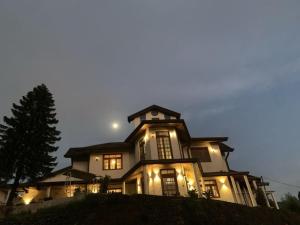 a large house with lights on top of it at Hotel Grand Sun Inn in Nuwara Eliya