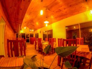 a restaurant with tables and chairs in a room at Hotel Grand Sun Inn in Nuwara Eliya +48 photos