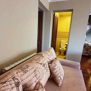 a living room with a couch with pillows at Departamento Caseros Centro in Salta