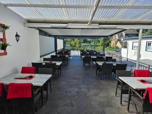 an empty dining room with tables and chairs at Hakans moselblick Ferienwohnung 2 in Treis-Karden