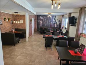 a restaurant with tables and chairs in a room at Hakans moselblick Ferienwohnung 2 in Treis-Karden