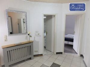 a bathroom with a vanity and a mirror and a sink at Saphir Suite in Westerdeichstrich