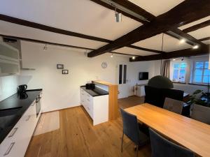 a kitchen and dining room with a wooden table in a room at Ferienwohnung Ederblick in Wabern