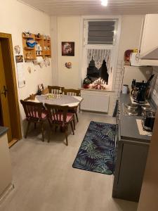 a kitchen and dining room with a table and chairs at Ferienwohnung An der Lutter in Bad Lauterberg +11 photos