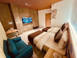 a hotel room with a bed and a couch at Terra Hotel Kawit in Kawit