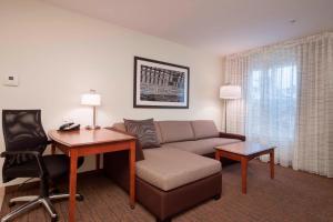 a living room with a couch and a desk at Residence Inn by Marriott San Antonio North Stone Oak in San Antonio +26 photos