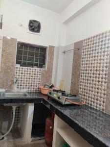 a kitchen with a sink and a counter top at Place away from home in Hyderabad +42 photos