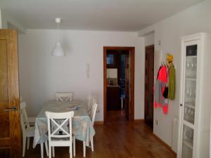 a dining room with a table and chairs and a closet at Apartamento en Panticosa in Panticosa