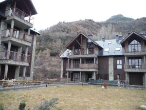a large building with balconies on the side of a hill at Apartamento en Panticosa in Panticosa