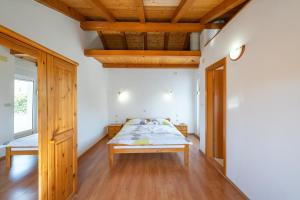 a bedroom with a bed and a wooden ceiling at Apartment Sea Sponge in Brodarica
