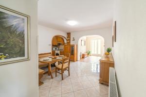 a kitchen and dining room with a table and chairs at Apartment Sea Sponge in Brodarica