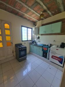 a kitchen with a stove and a sink in it at Depto. Centro Santiago del Estero in Santiago del Estero +10 photos