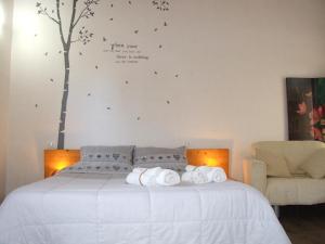 a bedroom with a bed with a tree on the wall at Barnaba Edera in Martina Franca