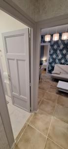 a door leading to a living room with a couch at S-e-r-a-l-y 1 in Égliseneuve-dʼEntraigues +18 photos