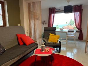 a living room with a couch and a table at Casita Lola Sol in Puntillo del Sol