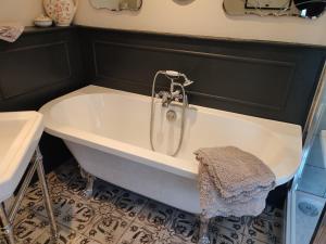 a bath tub with a shower in a bathroom at The Stable, Cuffern Manor Cottages in Haverfordwest +44 photos