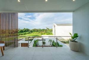 a room with a balcony with a view at Villa Somnia Bliss Private One Bedroom Retreat in Tumbak Bayuh