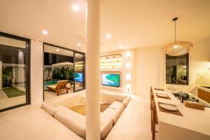 a living room with a couch and a table at Villa Somnia Bliss Private One Bedroom Retreat in Tumbak Bayuh +22 photos