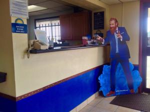a man is standing at a counter in a store at Days Inn by Wyndham Great Bend in Great Bend
