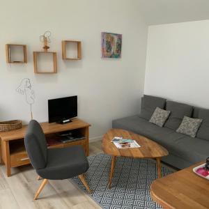a living room with a couch and a table at La Maisonnette de Senlis in Senlis