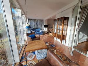 a living room with a couch and a table at Ferienwohnung Erlkron in Sandwig +37 photos