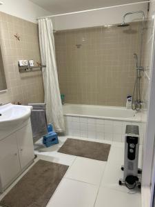 a bathroom with a tub and a sink and a shower at Casita Lola Sol in Puntillo del Sol +11 photos