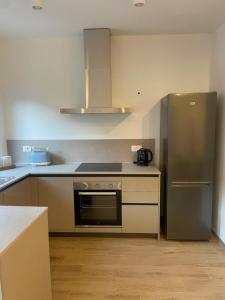 a kitchen with a stainless steel refrigerator and cabinets at Cà Marina in Ornavasso +6 photos