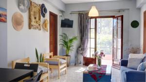 a living room with a couch and a table at Skaros House in Agios Georgios Pagon