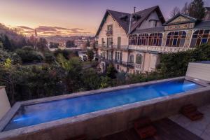 a swimming pool in front of a house at Belfry & Spa by Ligne St Barth in Lourdes