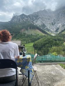 格罗莫Mountain Getaway Panoramic View的坐在桌子上看着山的女人