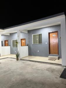 a large room with a large door and windows at Suitella in Cabo Frio