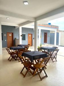 a group of tables and chairs in a courtyard at Suitella in Cabo Frio