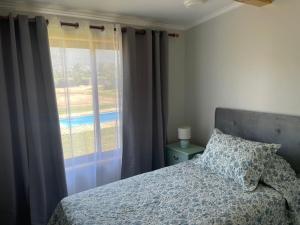 a bedroom with a bed and a large window at Florencia Boutique Cabin in Olmué +56 photos