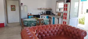 a living room with a couch and a table in a kitchen at House Valenor in Stompneusbaai