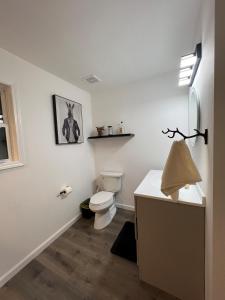 a white bathroom with a toilet and a sink at Downtown Bourbon House in Somerset +9 photos