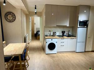 a kitchen with a washing machine and a dining room at New Gudauri Redco F1 in Gudauri