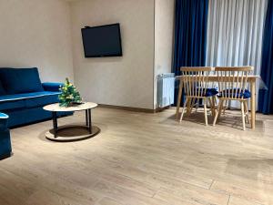 a living room with a couch and a christmas tree on a table at New Gudauri Redco F1 in Gudauri