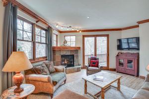 a living room with a couch and a fireplace at Cozy Avon Retreat w/ Private Deck & Pool Access! in Avon