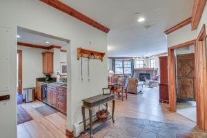 a kitchen with a table in the middle of a room at Cozy Avon Retreat w/ Private Deck & Pool Access! in Avon