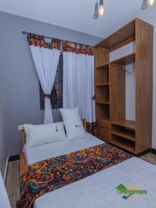 Postel nebo postele na pokoji v ubytování Ivy Homes - Kapchorwa