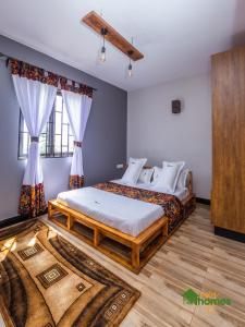 Postel nebo postele na pokoji v ubytování Ivy Homes - Kapchorwa