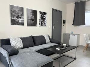 a living room with a couch and a table at Luffy's House in Alexandroupoli